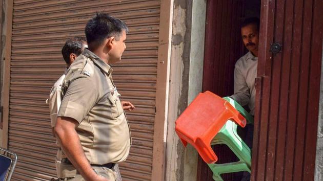 Delhi Police takes away the stools, which were supposed to be used by the Bhatia family members while committing suicide, at Burari in New Delhi on Friday, July 6, 2018.(PTI)