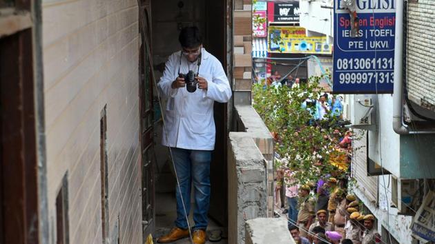 A forensic expert inspects the house, where 11 members of a family were found hanging from an iron grill, in Burari area of New Delhi on Sunday, July 1, 2018.(PTI)