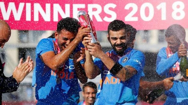 Indian cricket team captain Virat Kohli celebrates victory over England with the T20 series trophy. (reuters)