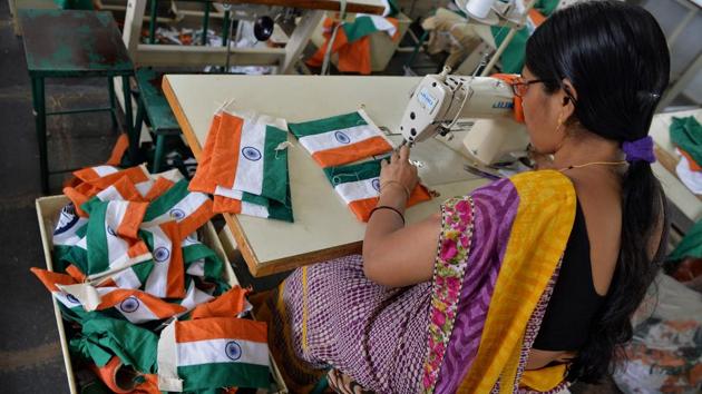 Last year, they women at KGSS produced around 60,000 Indian tricolours in various sizes of saffron, white and green against a blue wheel. (Manjunath Kiran / AFP)