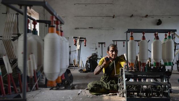 A KGSS employee spins cotton fibre into yarn to be later used to make the national flag. Around 400 people work for the state-owned company, most of them women. Production takes place at two sites: in Tulasigeri where the raw products are processed and in Bengeri around two hours away where the finished products are made. (Manjunath Kiran / AFP)