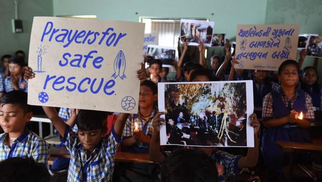 Schoolchildren hold placards and pictures during a prayer event for the safe rescue of young football players and their coach stuck in a cave in Thailand, in Ahmedabad on July 9, 2018. (AFP) Schoolchildren hold placards and pictures during a prayer event for the safe rescue of young football players and their coach stuck in a cave in Thailand, in Ahmedabad on July 9, 2018. (AFP)