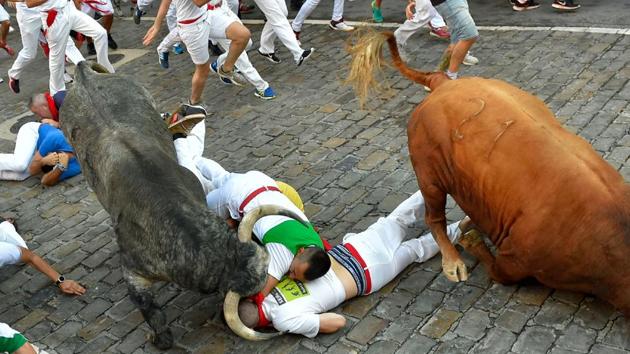 Five people have been injured at the festival, with at least one gored by a bull’s horns. Falls or trampling by the bulls cause most injuries. (Ander Gillenea / AFP) Five people have been injured at the festival, with at least one gored by a bull’s horns. Falls or trampling by the bulls cause most injuries. (Ander Gillenea / AFP)