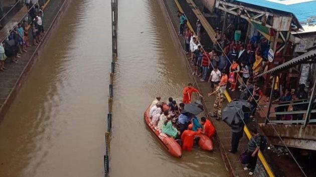 Palghar district residential collector Dr Navnath Jare said that the water level between Nallasopara and Vasai stations rose to more than two metres due to heavy rains and a high tide on Tuesday morning.(Western Railway/Twitter)