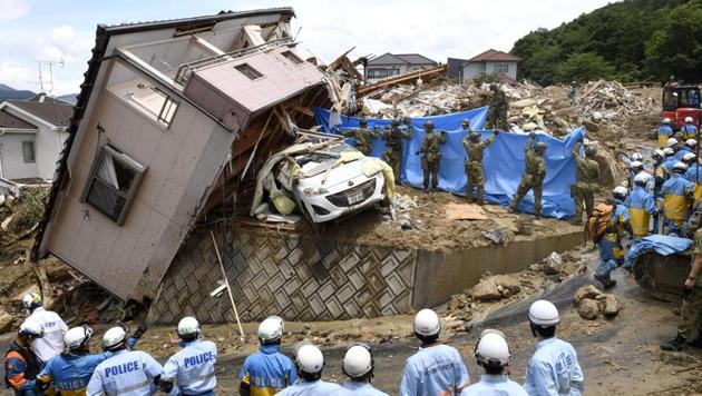 Rescue workers look for missing people in a house damaged by heavy rain in Kumano town, Hiroshima Prefecture, Japan on July 9, 2018. Rescuers combed through mud-covered hillsides and near riverbanks Tuesday to look for dozens of people still missing after days of heavy rains caused flooding and mudslides in southwestern Japan, where the death toll has risen to 141. (Kyodo via REUTERS) Rescue workers look for missing people in a house damaged by heavy rain in Kumano town, Hiroshima Prefecture, Japan on July 9, 2018. Rescuers combed through mud-covered hillsides and near riverbanks Tuesday to look for dozens of people still missing after days of heavy rains caused flooding and mudslides in southwestern Japan, where the death toll has risen to 141. (Kyodo via REUTERS)