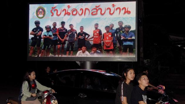 Motorists pass by a billboard displaying a photograph of the Thai children's football team "Wild Boar" and their coach with a message reading "welcome home brothers" in Chiang Rai on July 10, 2018, following their rescue.(AFP) Motorists pass by a billboard displaying a photograph of the Thai children's football team "Wild Boar" and their coach with a message reading "welcome home brothers" in Chiang Rai on July 10, 2018, following their rescue.(AFP)