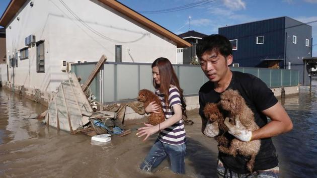 Residents rescue dogs from flooded area in Kurashiki, Okayama prefecture. The Japan Meteorological Agency said as much as 10 centimeters (3 inches) of rain per hour fell on large parts of southwestern Japan. (AFP) Residents rescue dogs from flooded area in Kurashiki, Okayama prefecture. The Japan Meteorological Agency said as much as 10 centimeters (3 inches) of rain per hour fell on large parts of southwestern Japan. (AFP)