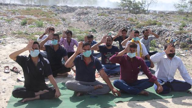 On June 21, on the occasion of the world yoga day, residents of the area had conducted yoga at the trenching ground wearing masks to highlight their plight.(HT File)