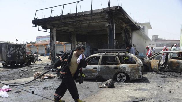 Firefighters work at the site of a deadly suicide attack in Jalalabad, the capital of Nangarhar province, Afghanistan on Tuesday.(AP Photo)