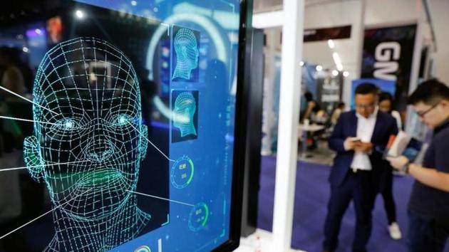 Visitors check their phones behind the screen advertising facial recognition software during Global Mobile Internet Conference (GMIC) at the National Convention in Beijing, China.(REUTERS/Damir Sagolj/Files) Visitors check their phones behind the screen advertising facial recognition software during Global Mobile Internet Conference (GMIC) at the National Convention in Beijing, China.(REUTERS/Damir Sagolj/Files)