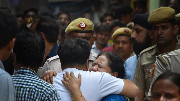Relatives mourn as Police carries out the investigation, after 11 members of a family- four men, three women and four girls- were found hanging from an iron grill in a house, in Burari area of New Delhi on Sunday, July 1, 2018. (PTI Photo) Relatives mourn as Police carries out the investigation, after 11 members of a family- four men, three women and four girls- were found hanging from an iron grill in a house, in Burari area of New Delhi on Sunday, July 1, 2018. (PTI Photo)