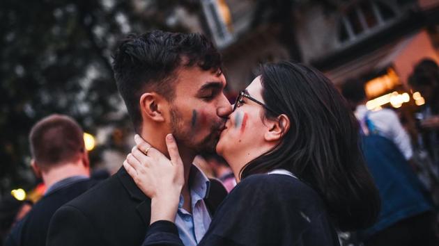 A couple kisses after France entered the final of FIFA World Cup. (AFP)