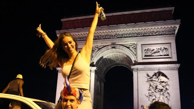 Delirious supporters draped in the Tricolor flag spilled on to Parisian boulevards as the blare of car horns reverberated through the French capital. (AFP)