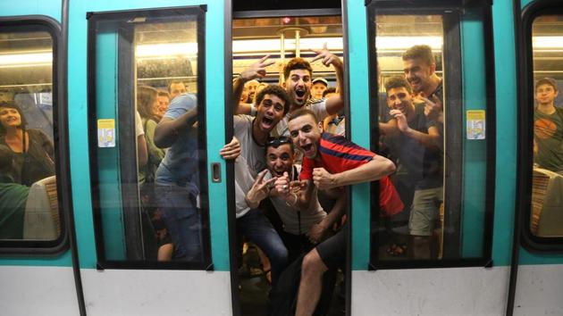 People celebrate France's 1-0 victory on board the metro in Paris. (AFP)