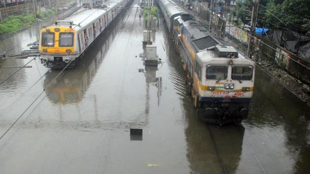 Local trains chug on the flooded railway tracks during rains at Parel, in Mumbai on Tuesday.(Bhushan Koyande/HT Photo)