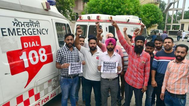 Employees protest against the company that runs the government ambulance project, outside the civil hospital in Amritsar on Wednesday. (Sameer Sehgal/HT) Employees protest against the company that runs the government ambulance project, outside the civil hospital in Amritsar on Wednesday. (Sameer Sehgal/HT)