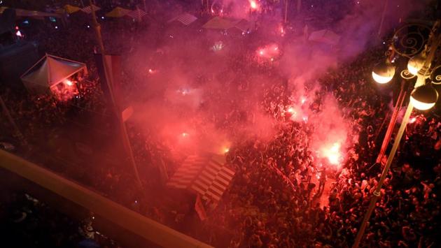 Cars and vans drove through the streets with Croatian flags stretched tightly across their bonnets, honking their horns at each other as workers clocked out for the day early and headed home to watch the game. (AFP)