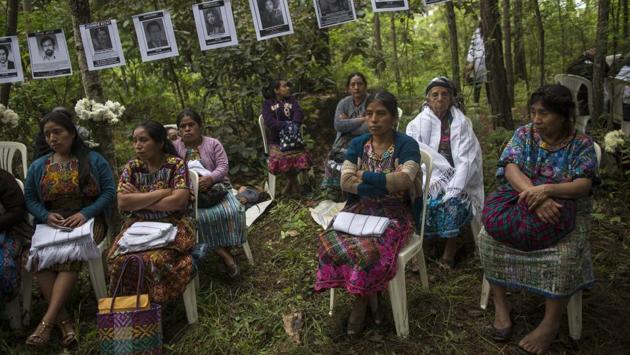 Women sit under the portraits of villagers who disappeared during the civil war. According to Rosalina Tuyuc, there was always a fire burning at this site, where soldiers threw gasoline and burned kidnapped villagers. (Rodrigo Abd / AP) Women sit under the portraits of villagers who disappeared during the civil war. According to Rosalina Tuyuc, there was always a fire burning at this site, where soldiers threw gasoline and burned kidnapped villagers. (Rodrigo Abd / AP)