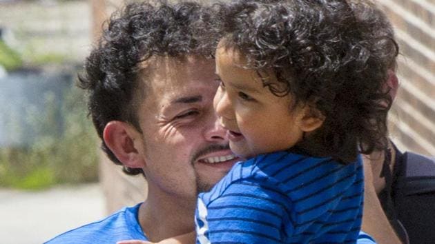 Ever Reyes Mejia is reunited with his 3-year-old son at the US Immigration and Customs Enforcement (ICE)? office building in Grand Rapids.(AP File Photo)