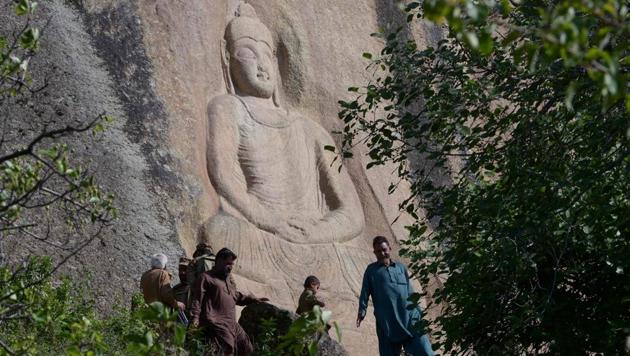 Visitors walk past the seventh-century rock sculpture of a seated Buddha carved into a mountain in Jahanabad town in the northwestern Swat Valley of Pakistan. The Buddha of Swat was dynamited by the Pakistani Taliban in 2007. Now it has been restored, a powerful symbol of tolerance in the traumatised Pakistani valley. (Abdul Majeed / AFP) Visitors walk past the seventh-century rock sculpture of a seated Buddha carved into a mountain in Jahanabad town in the northwestern Swat Valley of Pakistan. The Buddha of Swat was dynamited by the Pakistani Taliban in 2007. Now it has been restored, a powerful symbol of tolerance in the traumatised Pakistani valley. (Abdul Majeed / AFP)