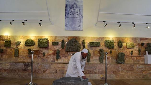 A worker cleans a rock with images of Buddha's feet at the museum in Mingora. Fazal Khaliq, a journalist and author in Mingora, thinks the threat to cultural heritage has been “minimised” through education and the use of social networks to spread a “soft, good” image. The museum in Mingora now welcomes mullahs “who like Buddhism”, says its curator, Faiz-ur-Rehman. “Before Islam, this was our religion,” he said. (Abdul Majeed / AFP) A worker cleans a rock with images of Buddha's feet at the museum in Mingora. Fazal Khaliq, a journalist and author in Mingora, thinks the threat to cultural heritage has been “minimised” through education and the use of social networks to spread a “soft, good” image. The museum in Mingora now welcomes mullahs “who like Buddhism”, says its curator, Faiz-ur-Rehman. “Before Islam, this was our religion,” he said. (Abdul Majeed / AFP)