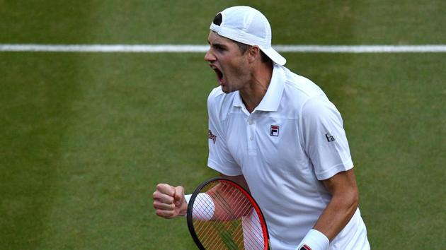 American tennis player John Isner celebrates winning against Canada's Milos Raonic during their men's singles quarterfinal at Wimbledon on Wednesday.(AFP)