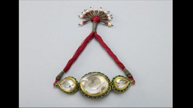 Armlet for the Koh-i-Noor diamond (gold, enamel, rock crystal, glass, rubies, pearls and silk, circa 1830). This rock crystal replica of the ‘Mountain of Light’ in the original Sikh setting captures the dazzling presence of one of history’s most scintillating treasures. (Royal Collection Trust)