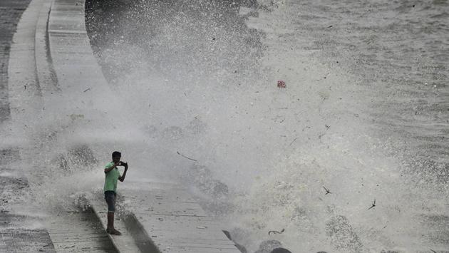 A youth takes a snapshot amid splashing waves along the Arabian Sea promenade at high tide in Mumbai on July 11, 2018. (Rafiq Maqbool / AP) A youth takes a snapshot amid splashing waves along the Arabian Sea promenade at high tide in Mumbai on July 11, 2018. (Rafiq Maqbool / AP)