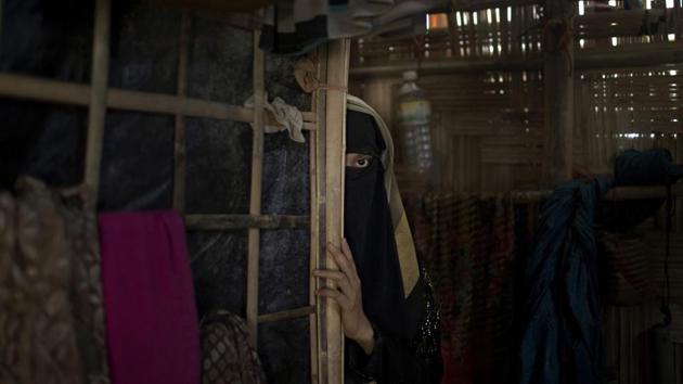 “A,” a 13-year old Rohingya, in Jamtoli refugee camp in Bangladesh. Soldiers had broken into her home back in Myanmar and raped her. Ever since, she had waited for her period to arrive. Gradually, she came to realize that it would not. The pregnancy was a prison she was desperate to escape. The rape itself had destroyed her innocence. But the baby of a Buddhist soldier could destroy her life. (Wong Maye-E / AP)