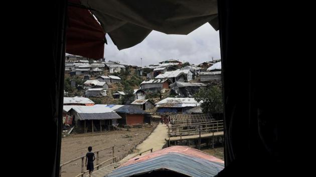 A boy walks over a bridge in Chakmarkul refugee camp. More than 10 months have passed since Myanmar’s security forces launched a campaign of rape and other brutalities against the Rohingya. Now, the babies from those assaults are being born. For many mothers, the births are tinged with fear. Not only are the infants reminders of their horrors, but the community often views rape as shameful, and bearing a baby conceived by Buddhists as sacrilege. (Wong Maye-E / AP File)
