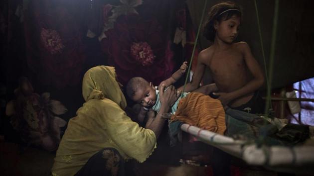 “M” refuses to carry her baby boy, and has her daughter take him away. She was raped by six soldiers after they strangled her 2-year-old son to death. She later found out she was pregnant and eventually gave birth to a child whom she only pretends to love. After she told her husband what had happened, he blames her for the rape and wants nothing to do with her or the baby. (Wong Maye-E / AP)