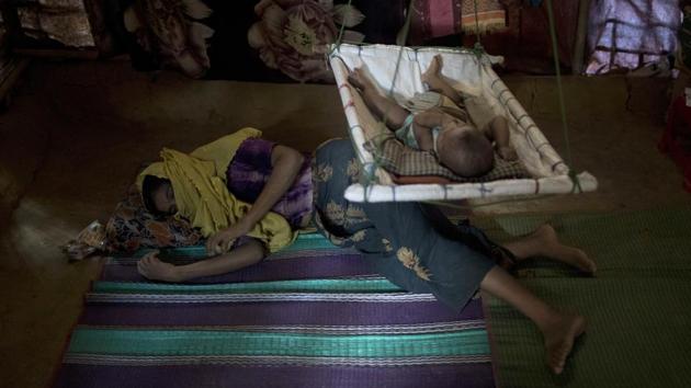 “M” lays on the floor of her shelter, uninterested. With her other pregnancies, she excitedly counted the days until delivery. With this baby, she paid no attention. She felt detached from the life growing inside her. When the infant finally arrived, he looked nothing like her other children. In his eyes, she saw her rapists. To look at him was to relive her attack, over and over again. (Wong Maye-E / AP)