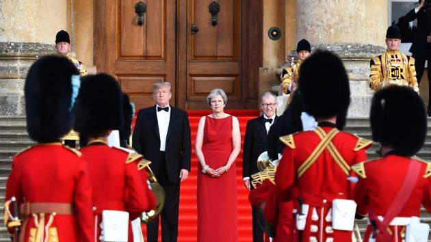 US president Donald Trump, from left, Theresa May, UK prime minister, and her husband Philip May watch a live military performance by the bands of the Scots, Irish and Welsh Guards ahead of a dinner at Blenheim Palace in UK on Thursday.(Bloomberg Photo)