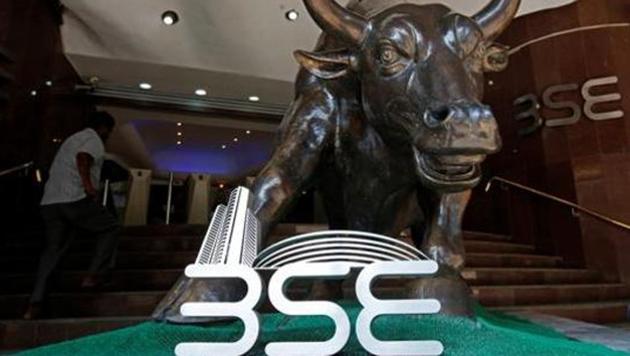 The Bombay Stock Exchange (BSE) logo is seen under a bull statue at the entrance of their building in Mumbai. (REUTERS File Photo) The Bombay Stock Exchange (BSE) logo is seen under a bull statue at the entrance of their building in Mumbai. (REUTERS File Photo)