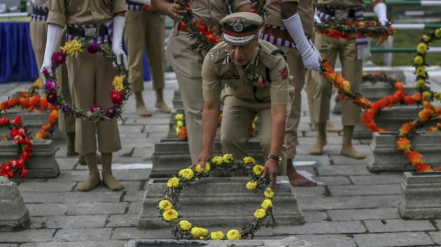 A police officer lays a wreath on a grave at Martyrs’ Graveyard in Srinagar. July 13 is observed as Martyrs' Day in memory of the day when the region's Hindu king ordered the execution of more than 20 Kashmiri Muslims in a bid to put down an uprising in 1931. (Dar Yasin / AP)