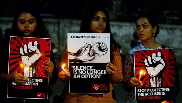 Activists hold candles and placards during a protest against rapes and crime against women. (AP FILE PHOTO) Activists hold candles and placards during a protest against rapes and crime against women. (AP FILE PHOTO)