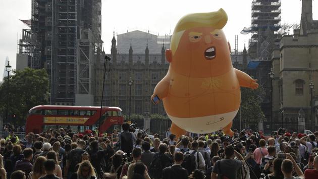 A six-meter high cartoon baby blimp of US President Donald Trump is flown as a protest against his visit, in Parliament Square backdropped by the scaffolded Houses of Parliament and Big Ben in London.(AP Photo)