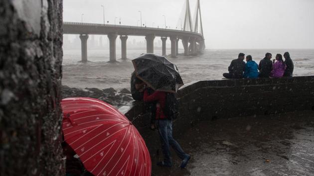 People use umbrellas to shield themselves from the rain as the Bandra-World Sea Link bridge stands in the background in the suburb of Bandra in Mumbai on July 10, 2018. (Karen Dias / Bloomberg) People use umbrellas to shield themselves from the rain as the Bandra-World Sea Link bridge stands in the background in the suburb of Bandra in Mumbai on July 10, 2018. (Karen Dias / Bloomberg)