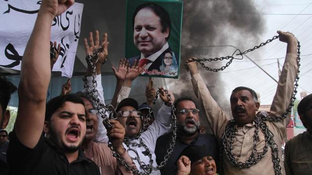 Supporters of Pakistan Muslim League-Nawaz (PML-N) chant slogans after the sentencing decision against former prime minister Nawaz Sharif, during a protest in Multan. Sharif was sentenced in absentia to 10 years in prison by a corruption court in Islamabad on July 6. (AFP) Supporters of Pakistan Muslim League-Nawaz (PML-N) chant slogans after the sentencing decision against former prime minister Nawaz Sharif, during a protest in Multan. Sharif was sentenced in absentia to 10 years in prison by a corruption court in Islamabad on July 6. (AFP)