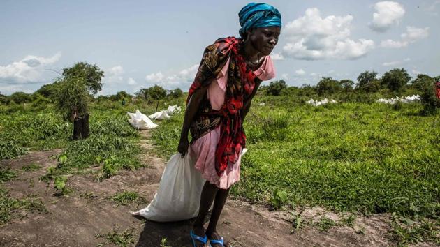 A woman drags a sack of maize and sorghum dropped from air by a World Food Programme (WFP) plane in Jeich village in Ayod County, northern South Sudan. The small village in the bush surrounded by swamps and the ongoing conflicts is isolated by the floodwater during the rainy season. (Patrick Meinhardt / AFP) A woman drags a sack of maize and sorghum dropped from air by a World Food Programme (WFP) plane in Jeich village in Ayod County, northern South Sudan. The small village in the bush surrounded by swamps and the ongoing conflicts is isolated by the floodwater during the rainy season. (Patrick Meinhardt / AFP)
