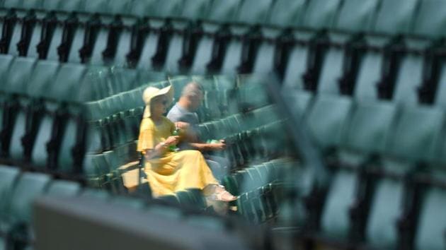A couple take their seats on court 1 on the sixth day of the 2018 Wimbledon Championships at The All England Lawn Tennis Club in Wimbledon, southwest London, England. (Oli Scarff / AFP) A couple take their seats on court 1 on the sixth day of the 2018 Wimbledon Championships at The All England Lawn Tennis Club in Wimbledon, southwest London, England. (Oli Scarff / AFP)
