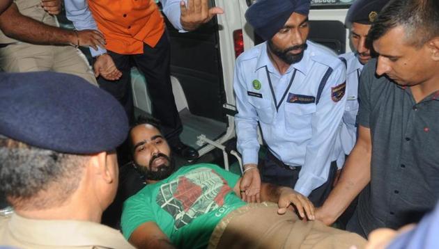 Gangster Dilpreet Singh being shifted to an ambulance at the PGIMER to be taken to the Chandigarh district courts on Friday. He was admitted to the GMCH, Sector 32, in the evening. (HT Photo) Gangster Dilpreet Singh being shifted to an ambulance at the PGIMER to be taken to the Chandigarh district courts on Friday. He was admitted to the GMCH, Sector 32, in the evening. (HT Photo)