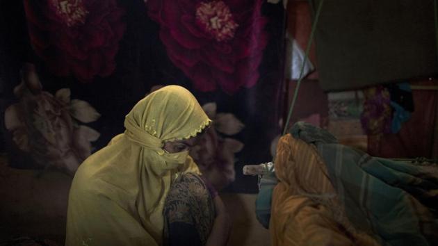 “M” who says her life is meaningless, sits in her shelter. Slowly, a few women have forgiven themselves, though there was never anything to forgive. Many who had abortions or gave birth, carried the weight of shame. Now, with the help of aid workers and emboldened themselves, some have begun to share their stories, focusing their fury on the men who brutalized them, rather than themselves. (Wong Maye-E / AP)