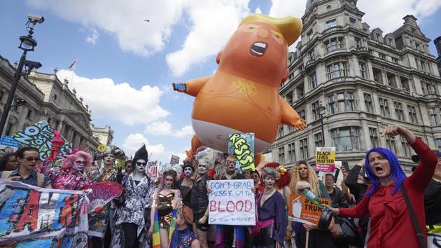 A giant balloon depicting US President Donald Trump as an orange baby joins drag queens and protesters against the UK visit of US President Donald Trump as they take part in a march and rally in London, England. (Niklas Hallen / AFP) A giant balloon depicting US President Donald Trump as an orange baby joins drag queens and protesters against the UK visit of US President Donald Trump as they take part in a march and rally in London, England. (Niklas Hallen / AFP)