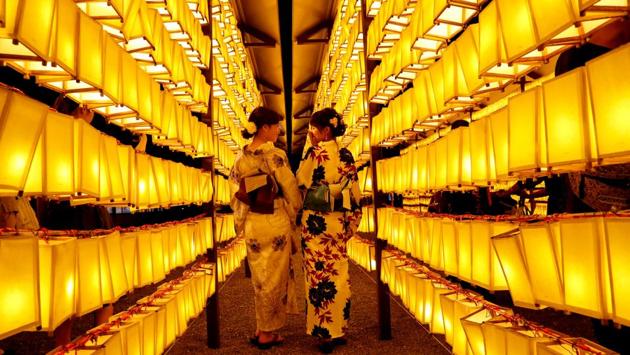 Women in yukatas, or casual summer kimonos, pose to take photos between paper lanterns during the annual Mitama Festival at the Yasukuni Shrine, where more than 2.4 million war dead are enshrined, in Tokyo, Japan. (Kim Kyung-Hoon / REUTERS) Women in yukatas, or casual summer kimonos, pose to take photos between paper lanterns during the annual Mitama Festival at the Yasukuni Shrine, where more than 2.4 million war dead are enshrined, in Tokyo, Japan. (Kim Kyung-Hoon / REUTERS)