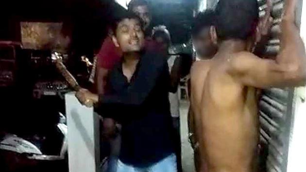 The victims were stripped completely naked and lined up against a shuttered shop along Andhmook bypass road to face action for allegedly stealing 120 litres of diesel. (Video screenshot) The victims were stripped completely naked and lined up against a shuttered shop along Andhmook bypass road to face action for allegedly stealing 120 litres of diesel. (Video screenshot)