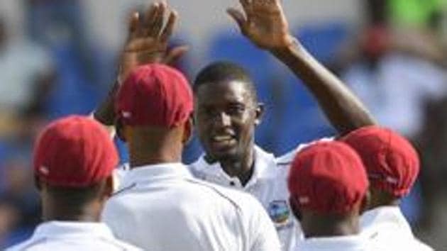 Jason Holder (3L) of West Indies celebrates the dismissal of a Bangladesh batsman.(AFP)