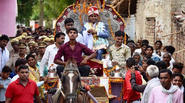 Sanjay Jatav’s wedding procession passed through Nizampur village to the bride’s house in Uttar Pradesh’s Kasganj, near Aligarh, on Sunday.(Burhaan Kinu/HT Photo)