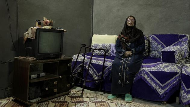 85-year-old Naemah Hussein sits in her home ‘tahgeer’ Eneiba village, northern Aswan. Speaking Arabic haltingly with a heavy Nubian accent, Hussein, said her house in her original home village of Eneiba was right on the banks of the Nile, where she baptized her first two children. (Nariman El-Mofty / AP) 