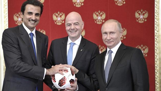 Russian President Vladimir Putin (R), FIFA President Gianni Infantino (C) and Emir of Qatar Sheikh Tamim bin Hamad al-Thani pose for a photo during their meeting in the Kremlin in Moscow on Sunday.(AP)